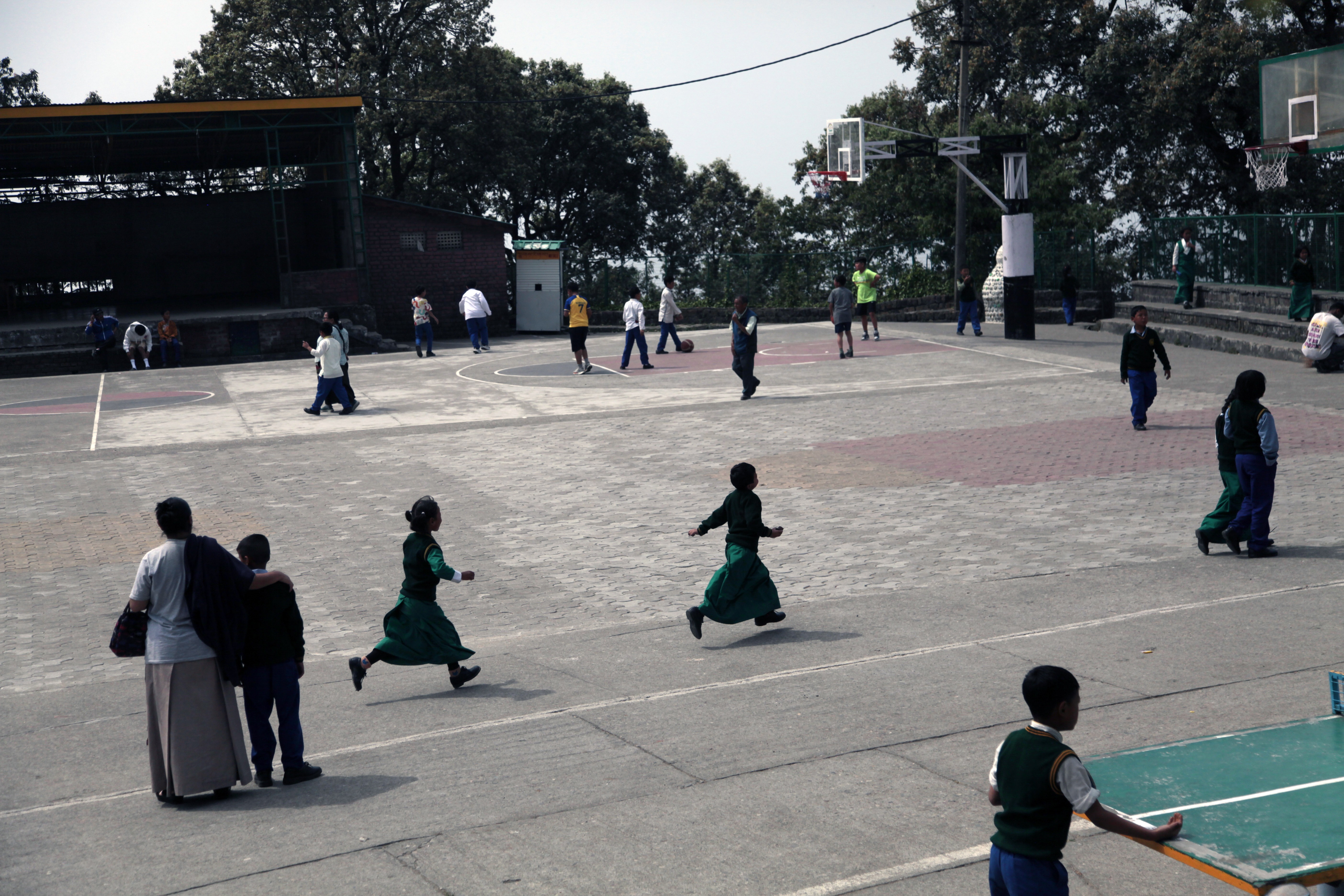 Students run on the sports ground at the Tibetan Children